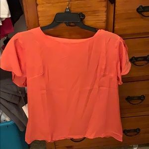 Coral blouse with ruffle sleeves